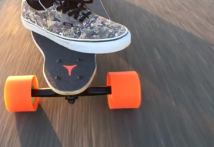 longboard with orange wheels on the move