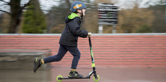 boy riding the scooter fast