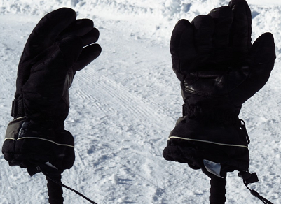 gloves resting on top of skis