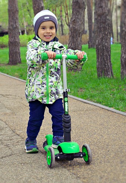 kid riding his 2 front wheel 1 rear wheel bike