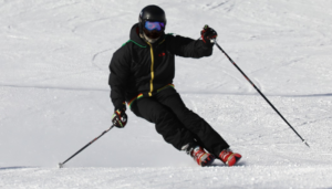 Man with black jacket and pants doing ski