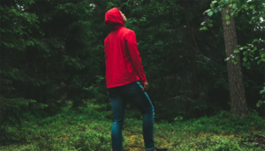 Man on the forest wearing red jacket