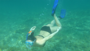 Woman under the water diving snorkeling