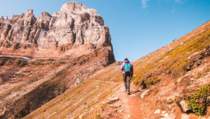 Man with backpack walking on a rocky mountain