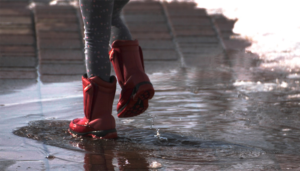 Person wearing red rain boots