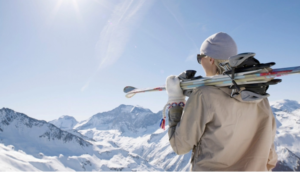 woman with skis on top of mountain